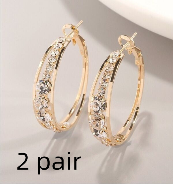Gold hoop earrings with sparkling crystals, minimalist luxury jewelry design