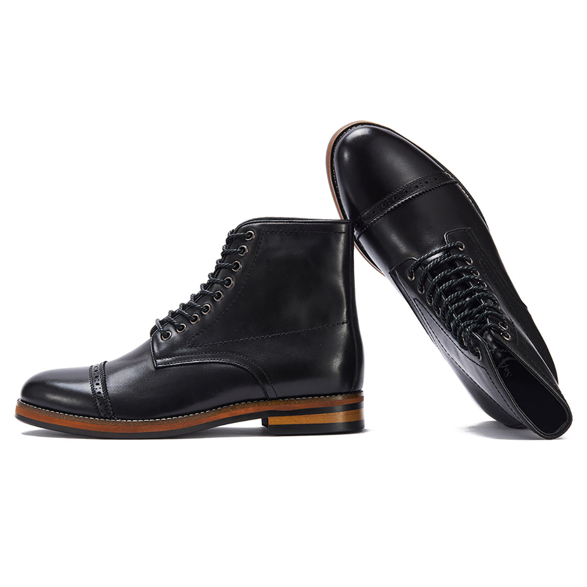 Black leather cap-toe boots with brogue detailing and contrast sole, minimalist luxury footwear