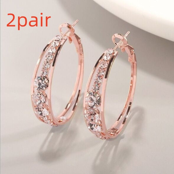 Rose gold hoop earrings with sparkling crystals, minimalist luxury jewelry design