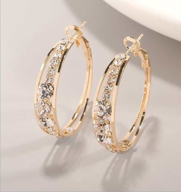 Gold hoop earrings with sparkling crystals, minimalist luxury jewelry design