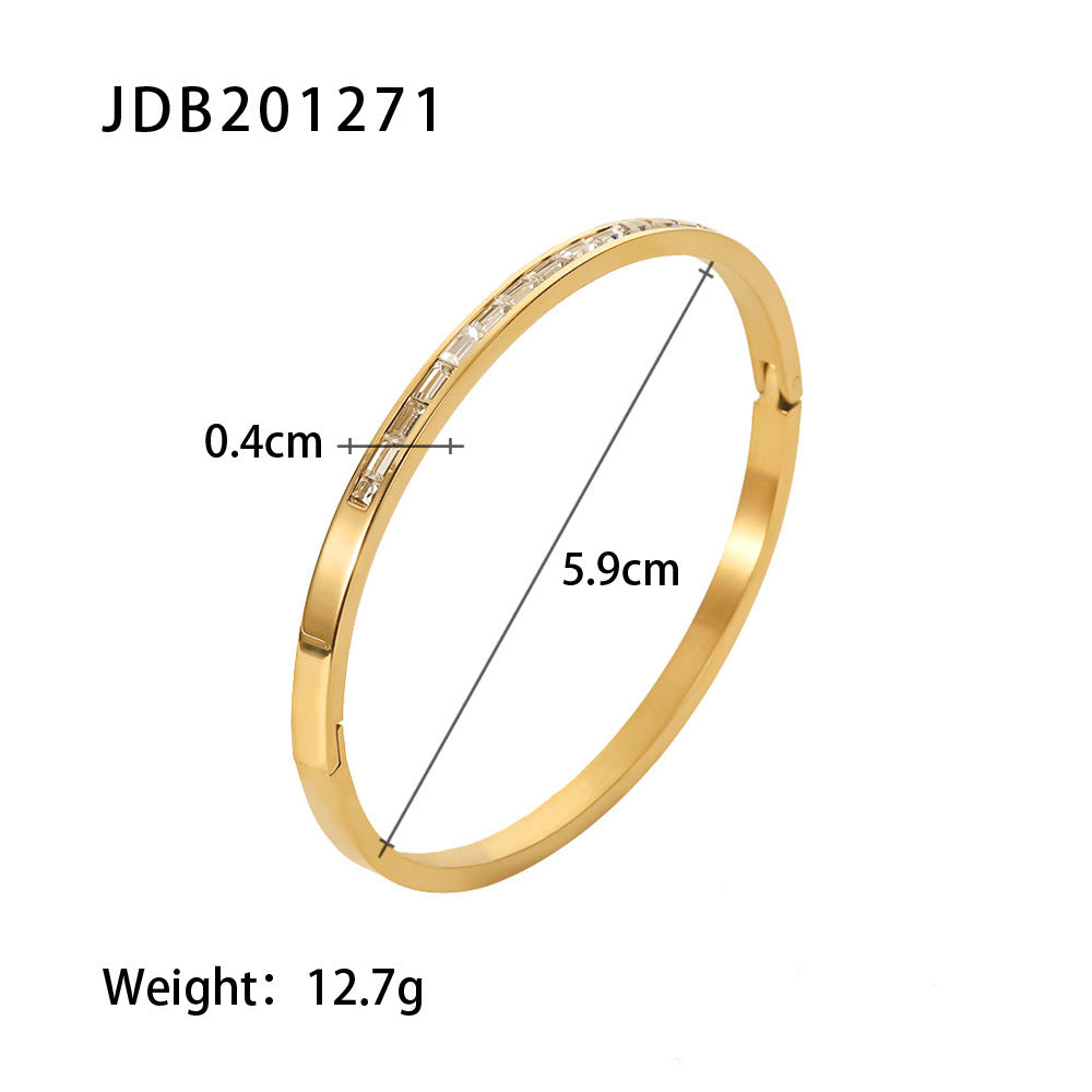 Gold bangle with baguette crystals, 0.4cm width, 5.9cm diameter, 12.7g weight — minimalist luxury jewelry