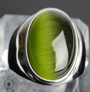 Green cat's eye gemstone ring in polished silver setting, minimalist luxury jewelry