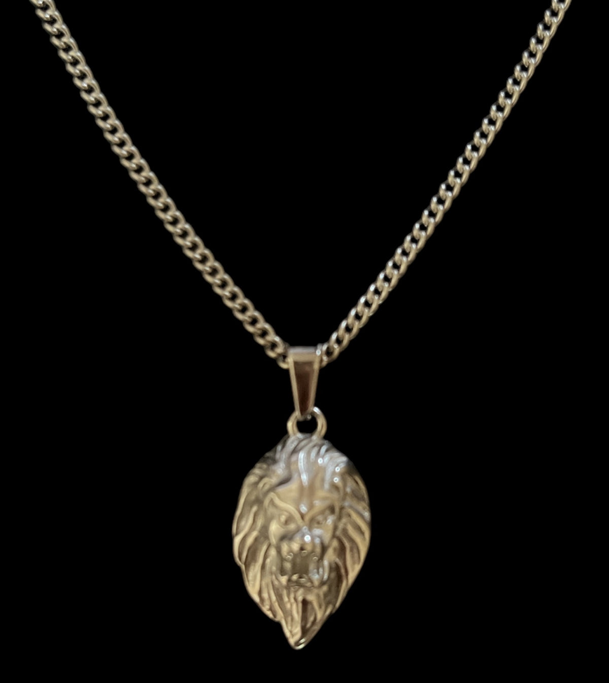 Luxury lion head pendant necklace with detailed mane on curb chain, minimalist design
