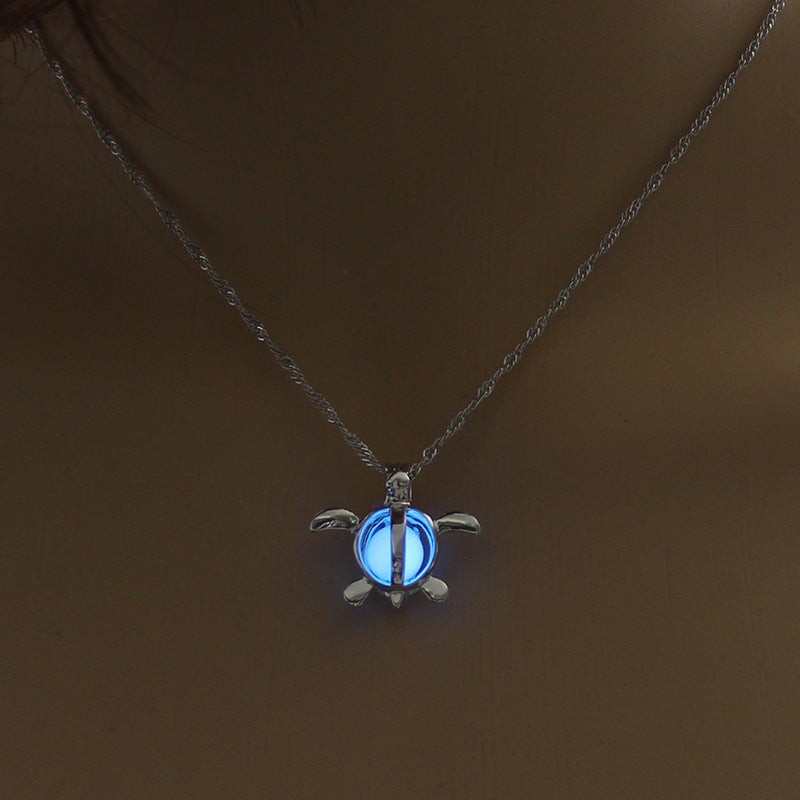 Glowing blue turtle pendant necklace, minimalist luxury jewelry design