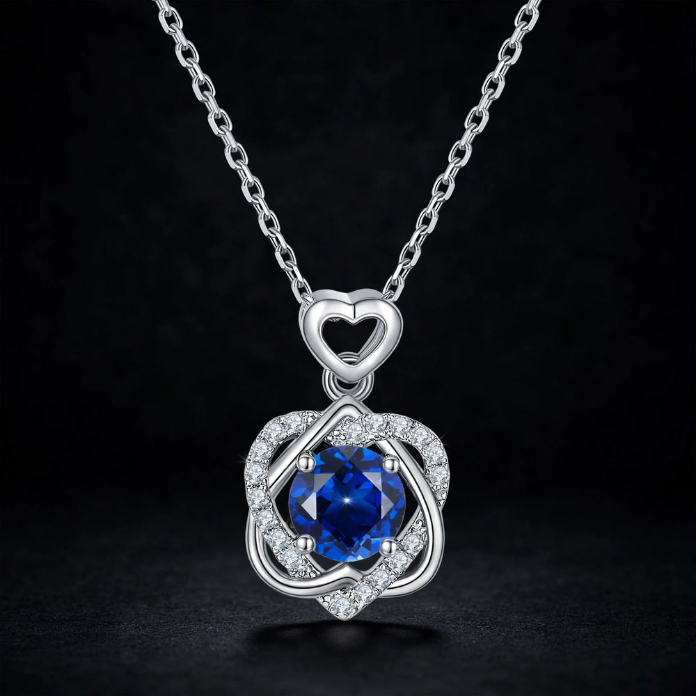 Silver heart pendant necklace with blue pavé stones, luxury jewelry product photography